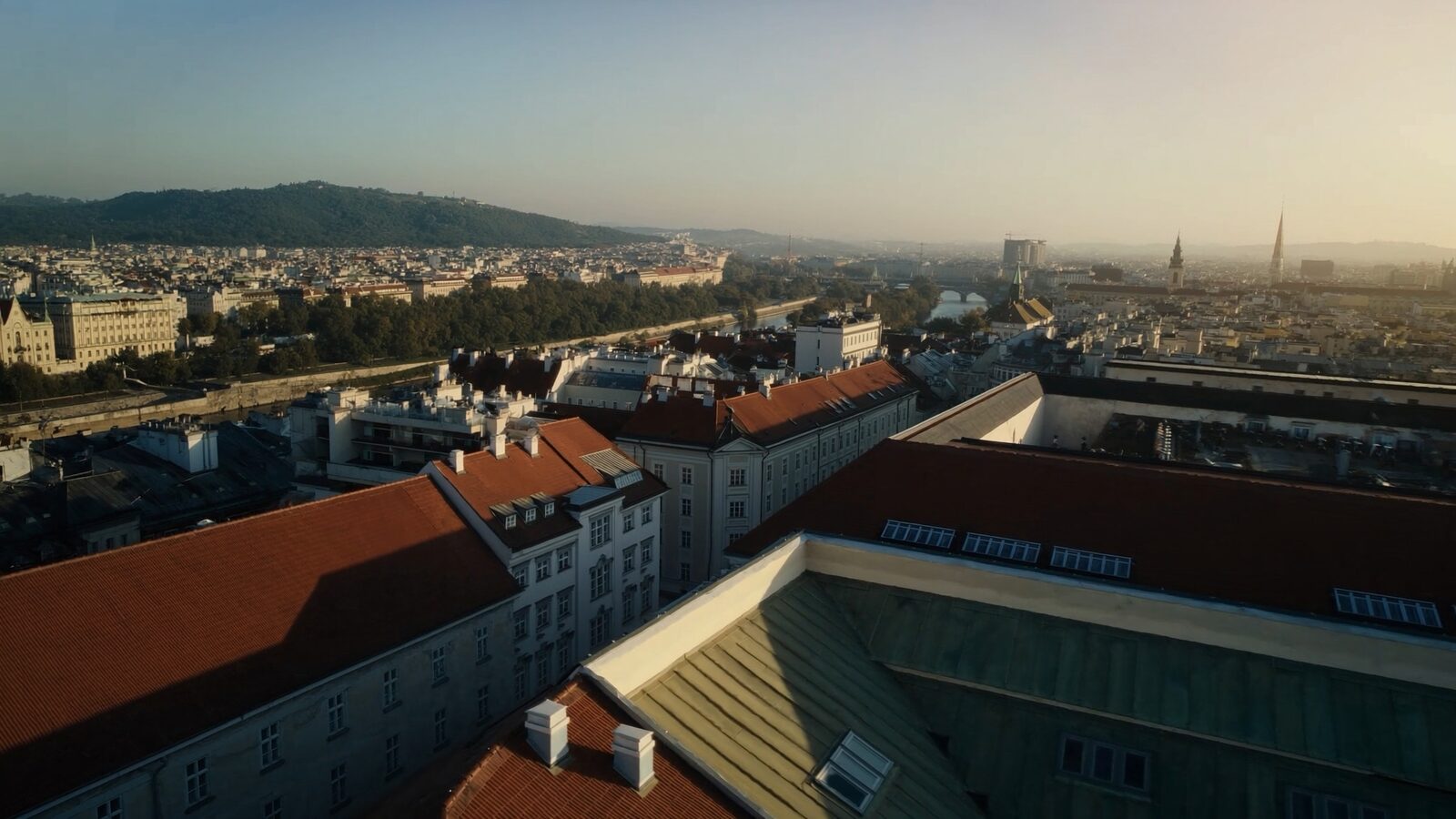 Aerial view of Vienna rooftops and the Danube at golden hour