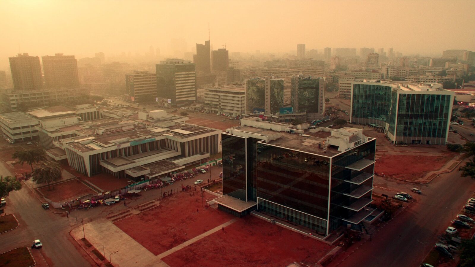 Aerial view of a modern West African city skyline at golden hour