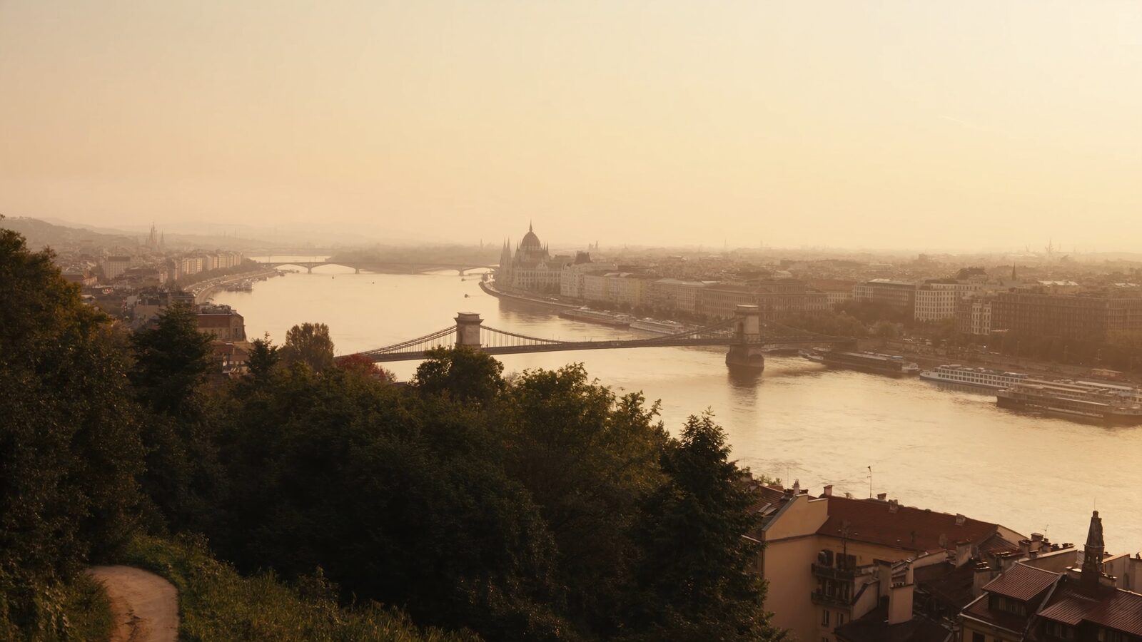 Dawn over the Danube in Budapest with mist on the water and bridges catching warm light