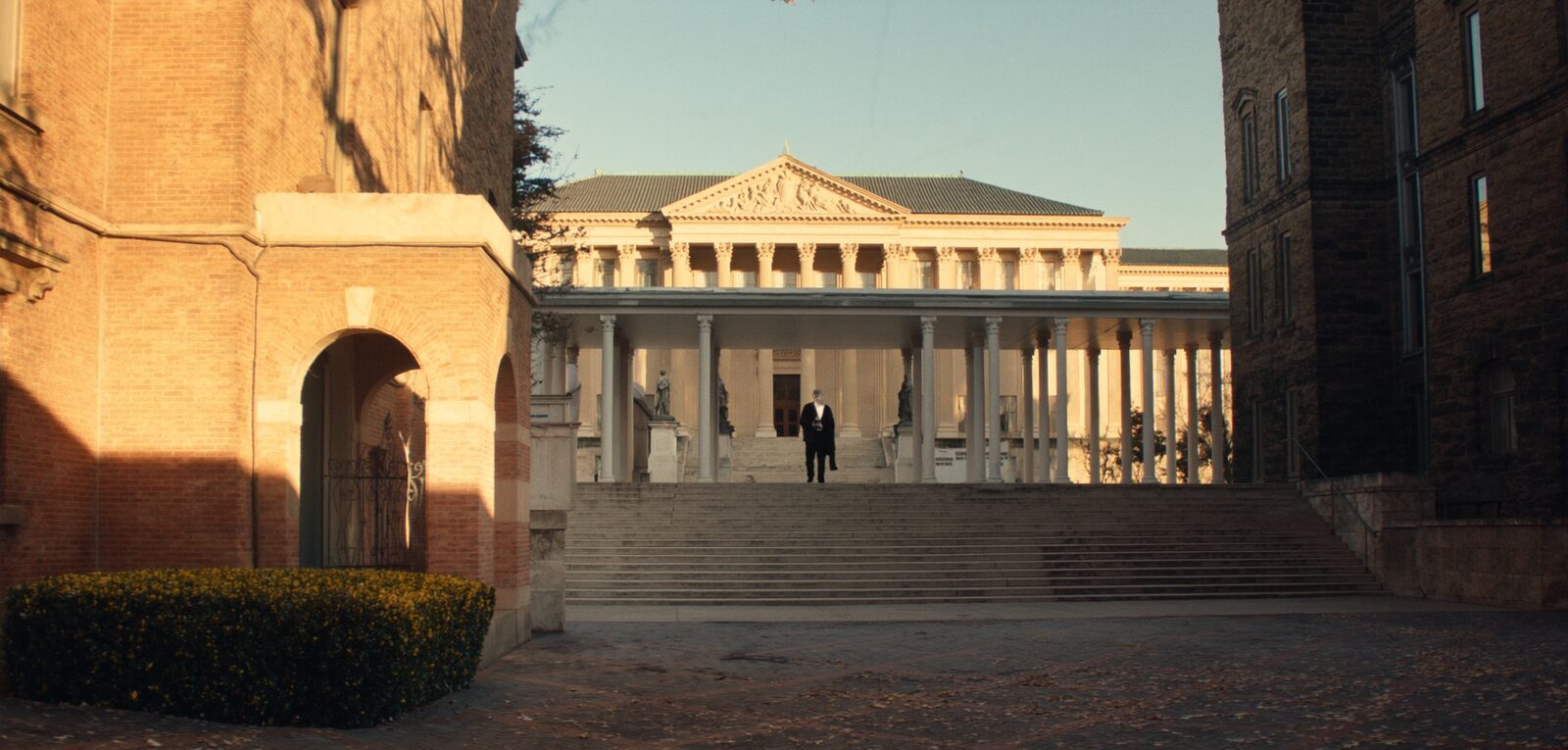 The grand stone steps and columns of an American university library at golden hour